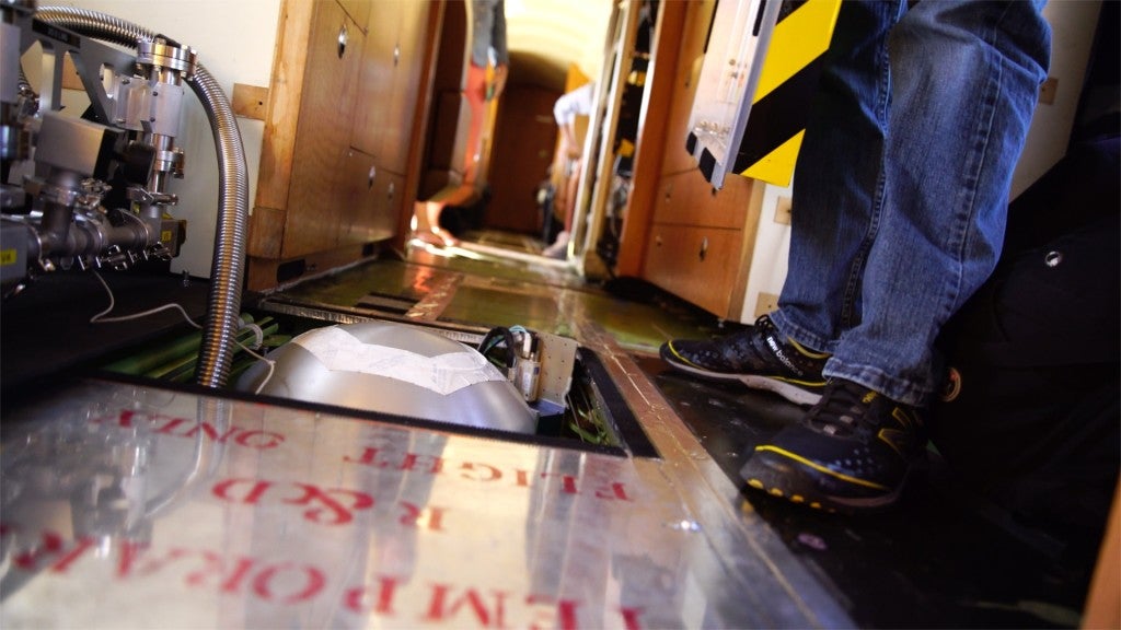 Looking like a very large teakettle, PRISM is recessed into the floor the plane. Specifically designed to observe coastal systems, after a successful test run in Hawaii, the instrument will be used in the CORAL campaign to collect information about coral reef ecosystems across the Pacific.