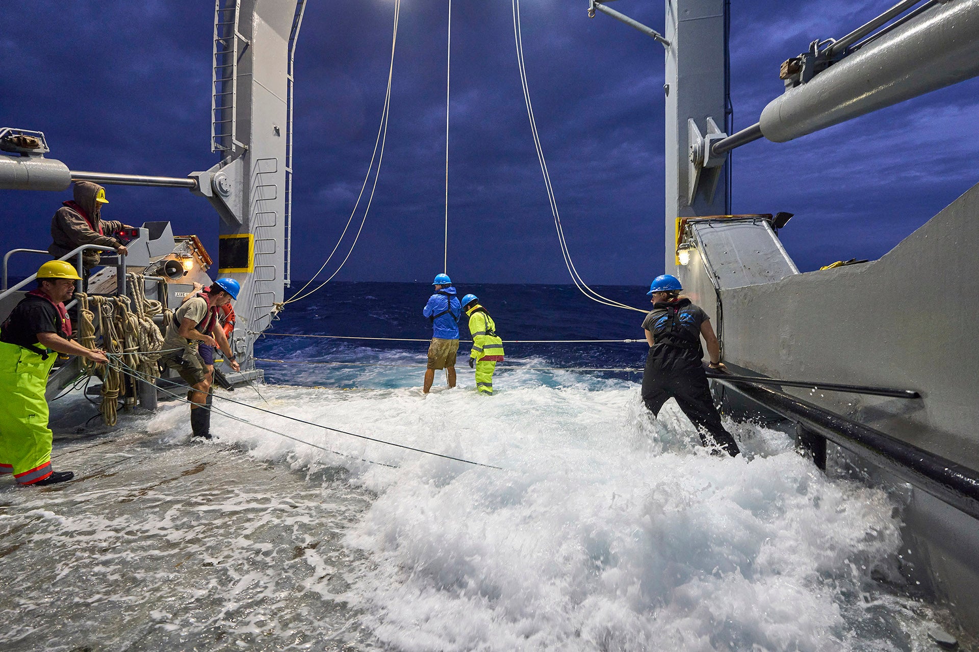 BATS team works ont eh aft deck during heavy weather.